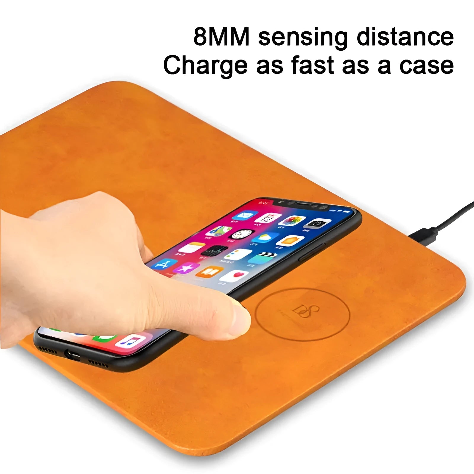 Brown leather desk mouse pad with integrated wireless charging for mobile phones.