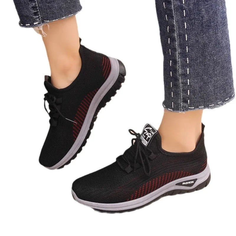 Women's mesh breathable casual sneakers in black with cross strap design and round toe