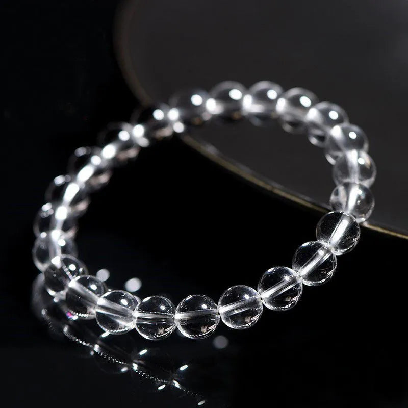 Natural white crystal bracelet with round beads, showing unisex geometry design on a wrist.