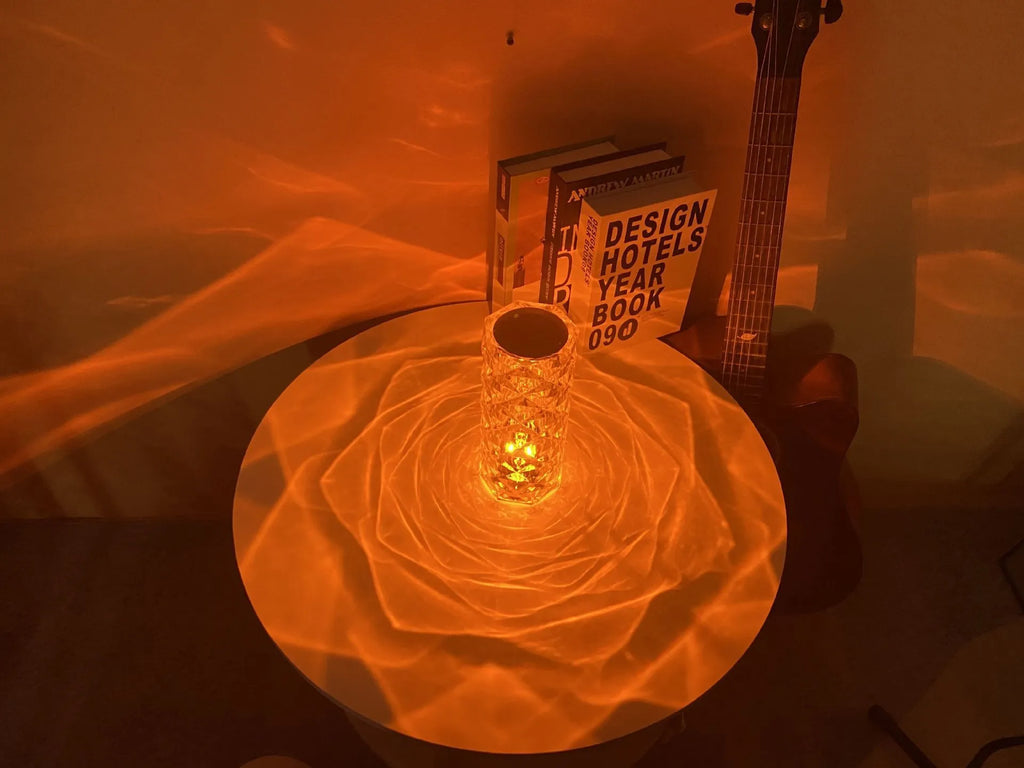 Creative acrylic crystal rose LED table lamp with adjustable three-colour lighting on a wooden surface.