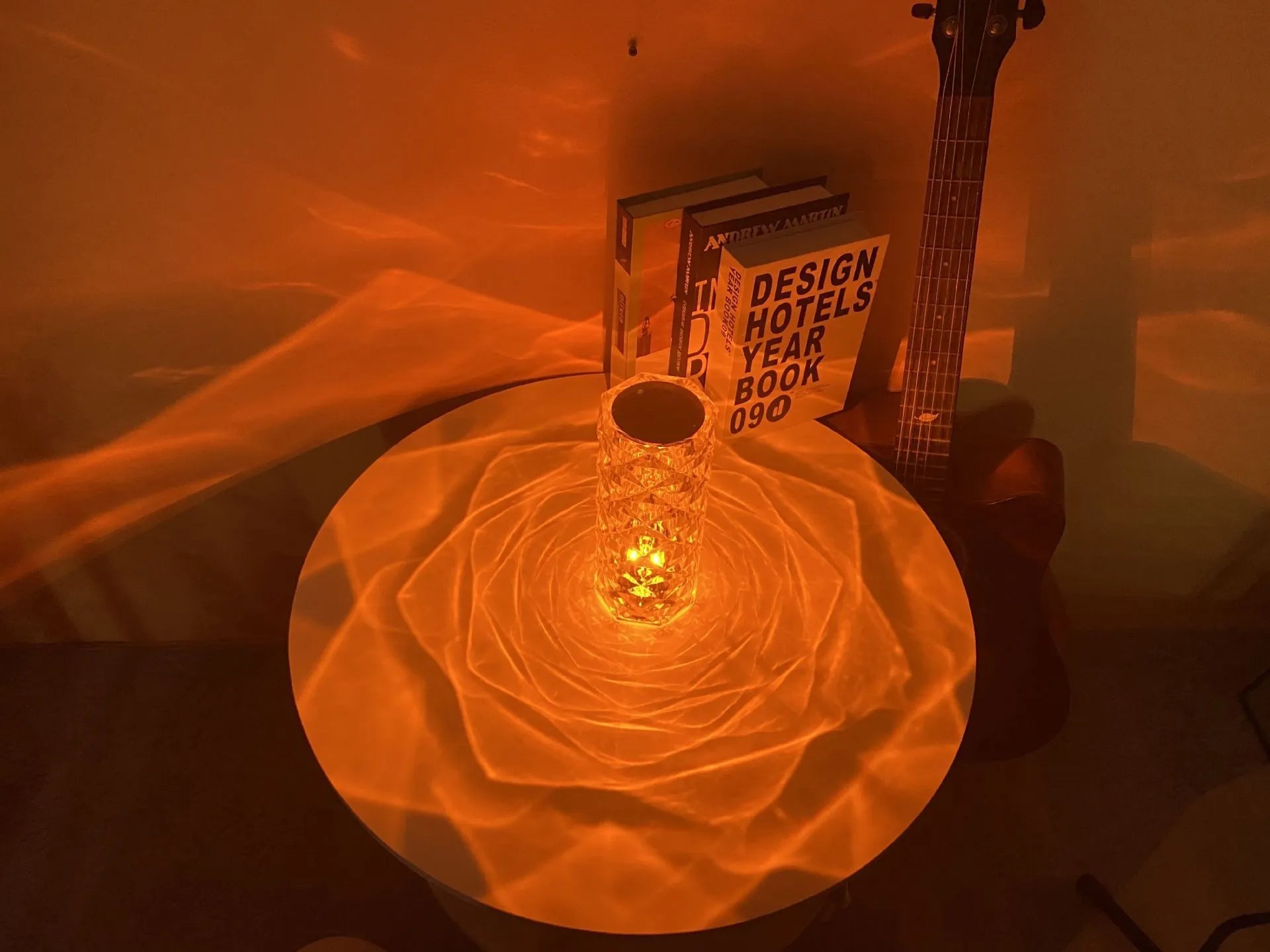 Creative acrylic crystal rose LED table lamp with adjustable three-colour lighting on a wooden surface.