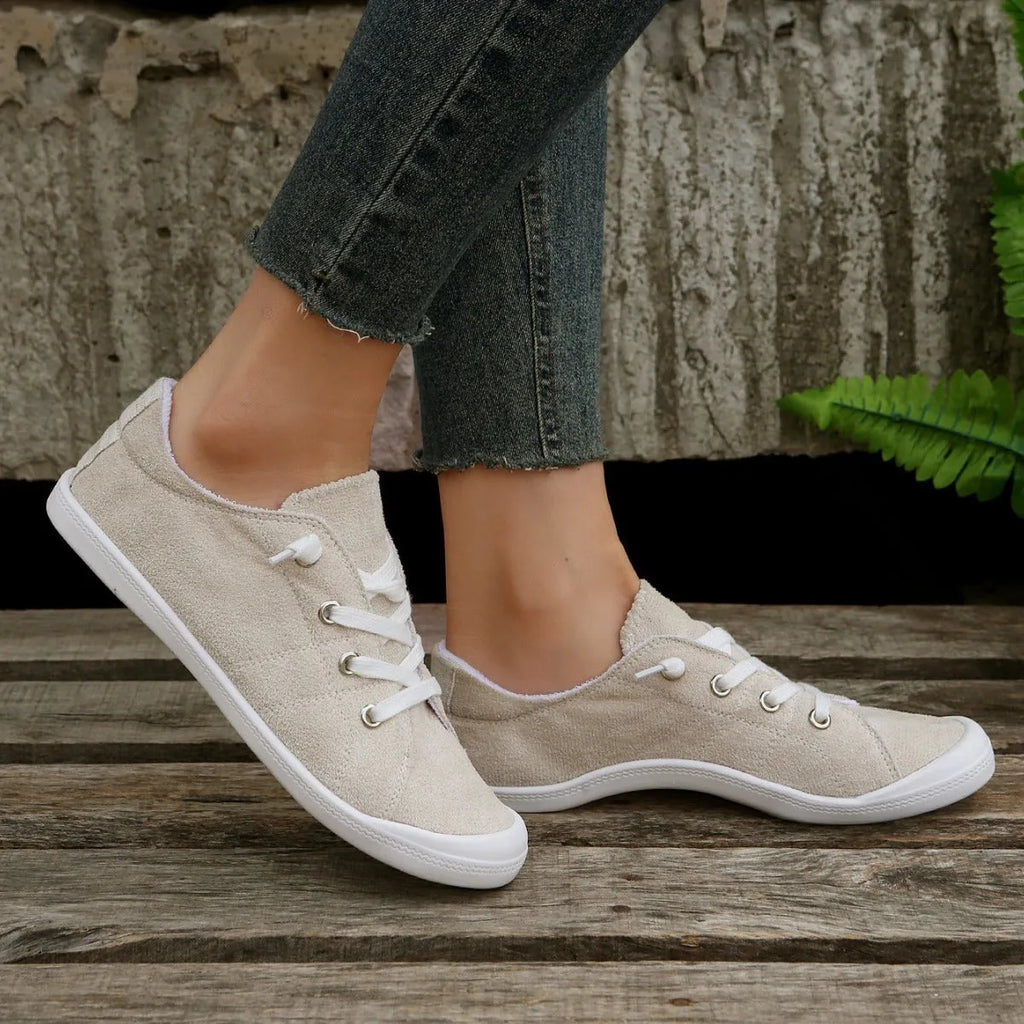 Women's creamy white fabric casual sneakers with low-top design and rubber sole