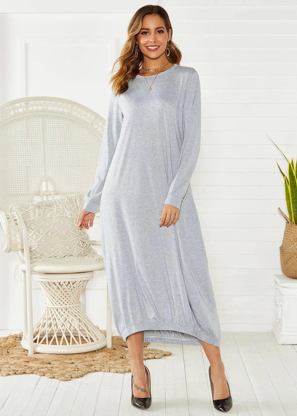 Women's loose black lantern dress with lace-up crew neck and long sleeves.