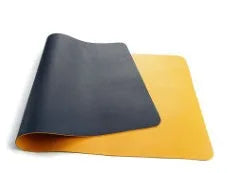 Leather desk mat in multiple sizes and colours for office or study use, shown on a desk with a computer mouse.