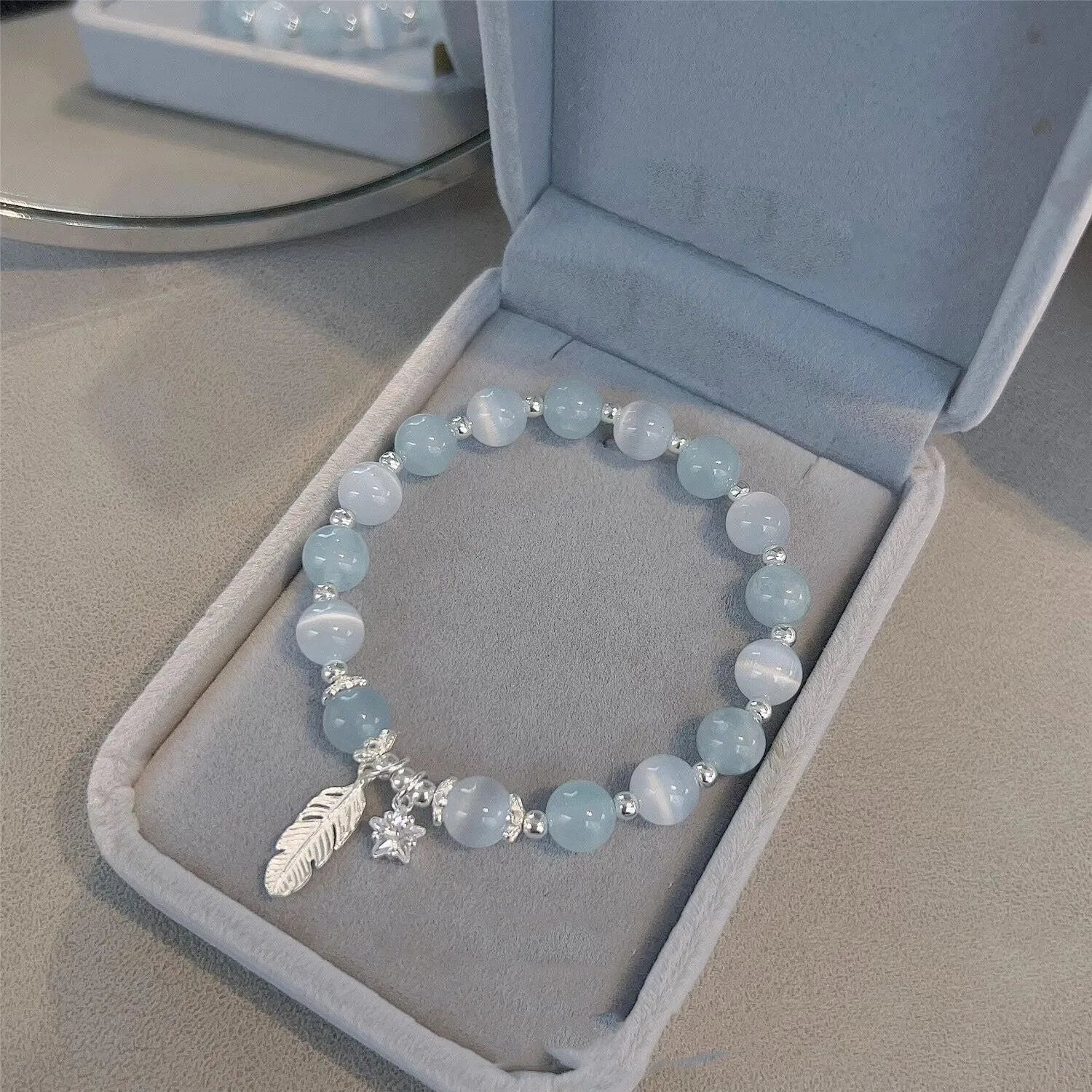 Korean style glass crystal bracelet with feather XingX blue moonlight colour and eight Awn star design