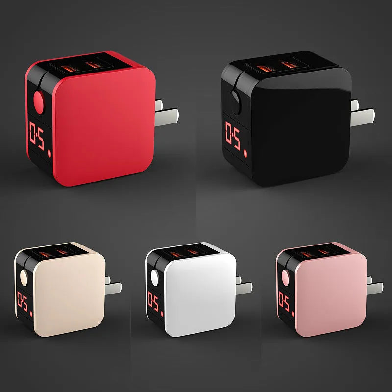 Black dual USB fast charger with digital display showing charging current, plugged into a UK wall socket.