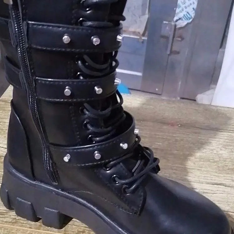 Women's black mid-calf knight boots with a large metal buckle and side zip.