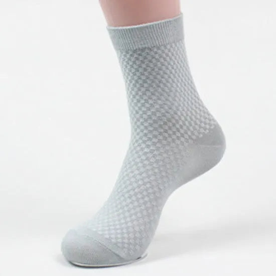 Men's bamboo fibre business socks in grey with a small-square pattern, shown on a foot.