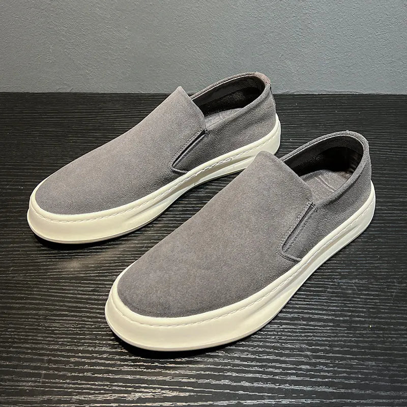 Men's grey casual shoes with round toe design and sewing line detailing showing rubber soles