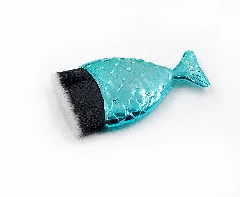 Blue fishtail makeup brush with artificial fibre bristles and short plastic handle on white background