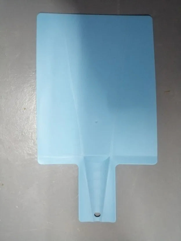 Green folding plastic cutting board with non-slip texture and hanging hole on kitchen countertop