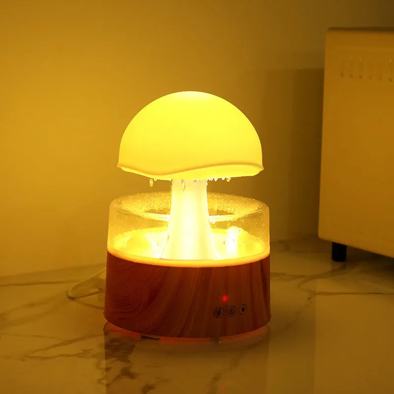 White cloud-shaped ultrasonic humidifier producing rainfall mist with colour-changing night light effects