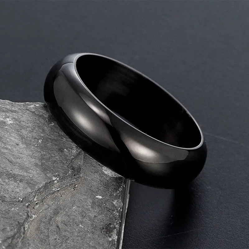 A glossy electroplated titanium steel ring shown in gold, black, and steel colour on a grey background.