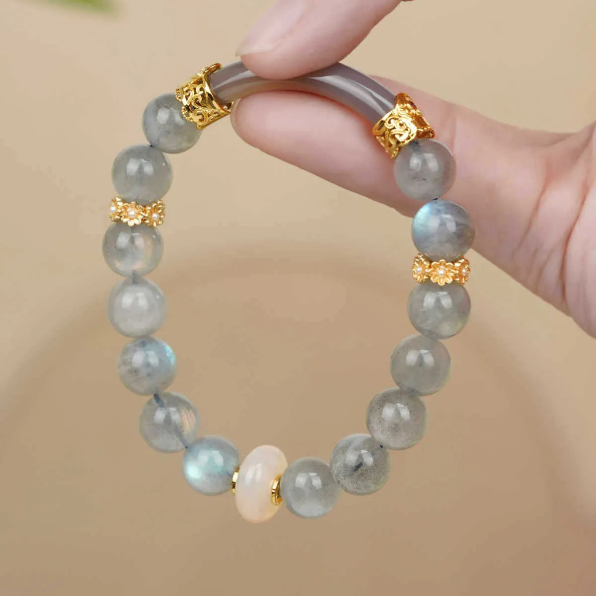 Handcrafted gray moonstone half bracelet for women with 8mm round agate beads on a wrist.