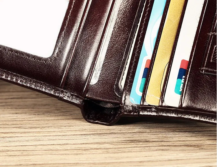 Men's black leather wallet open, showing internal card slots, photo slot, change pocket and hidden compartment.