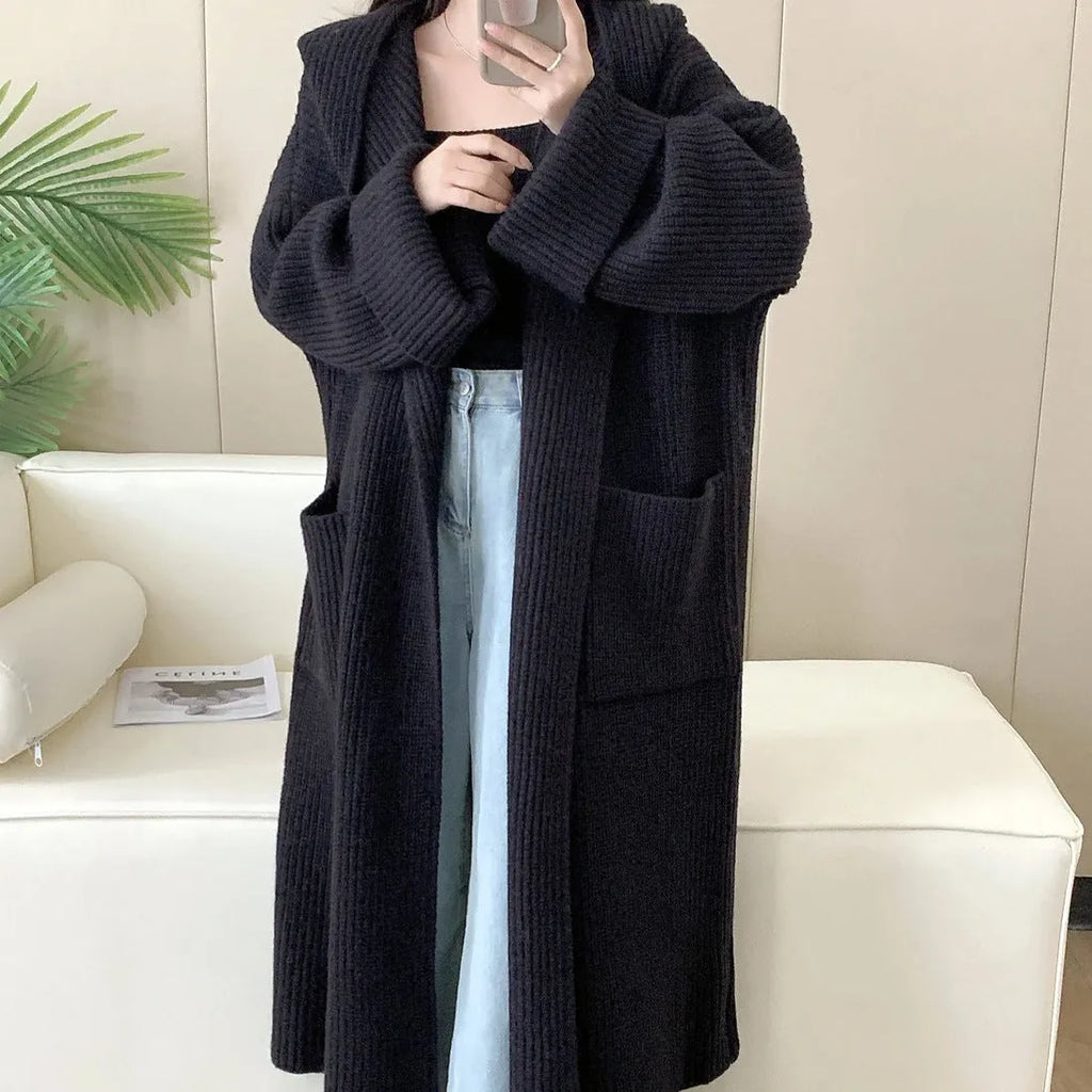 Women's milky white loose hooded cardigan coat with long raglan sleeves on a hanger.