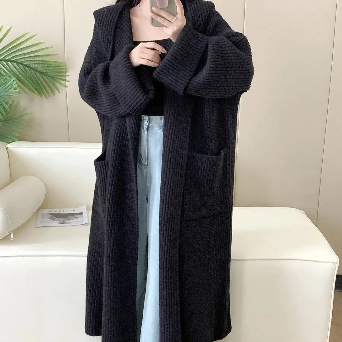 Women's milky white loose hooded cardigan coat with long raglan sleeves on a hanger.