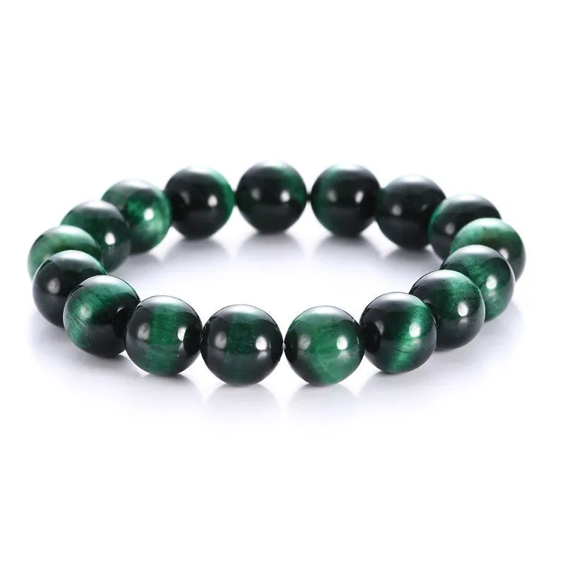 Green Tiger Eye stone bracelet with polished geometric beads on a wrist