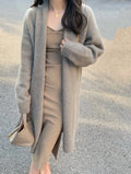 Women's khaki knitted v-neck cardigan with long sleeves on a hanger.