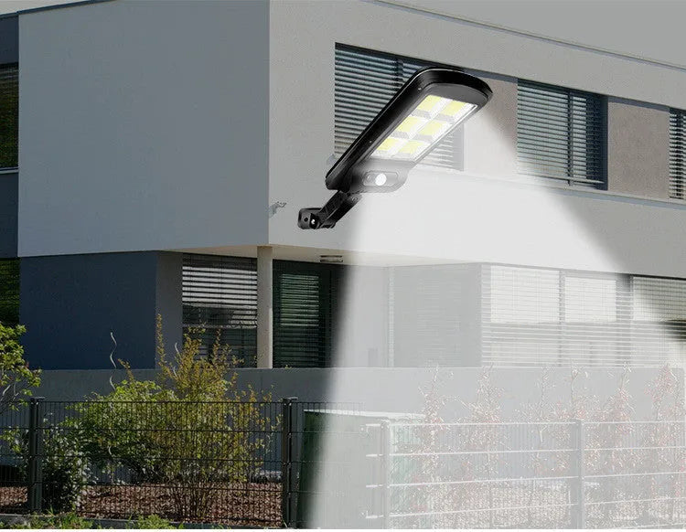 Black solar-powered outdoor wall light with motion sensor for gardens and pathways