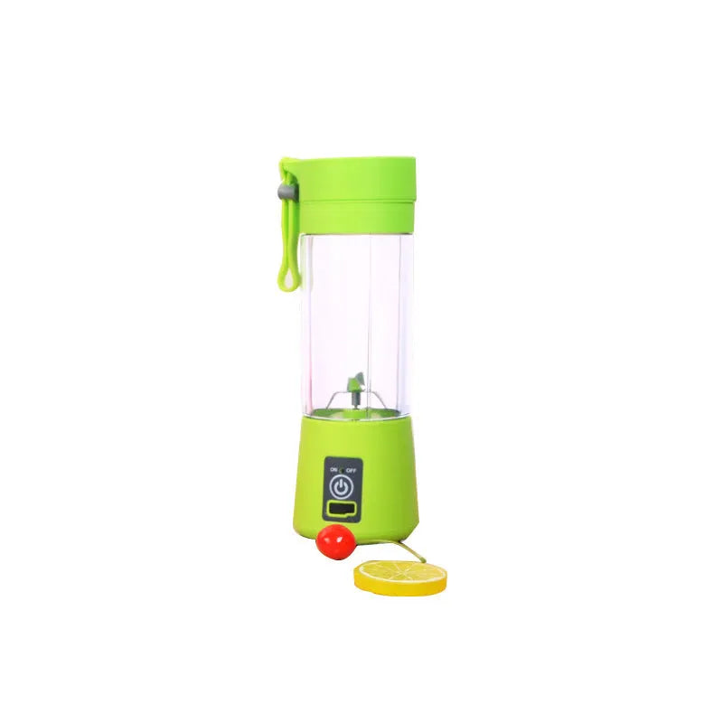 Mini USB electric fruit juicer with pink 400ml cup and stainless steel blades on a table.