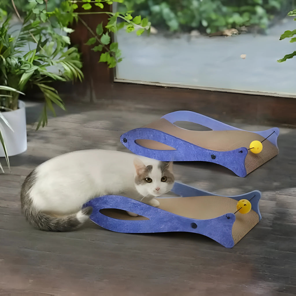 Blue fish-shaped cardboard cat scratcher lounge with a dangling bell ball toy.
