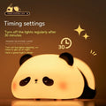 Cartoon panda-shaped silicone night light for children on a table.