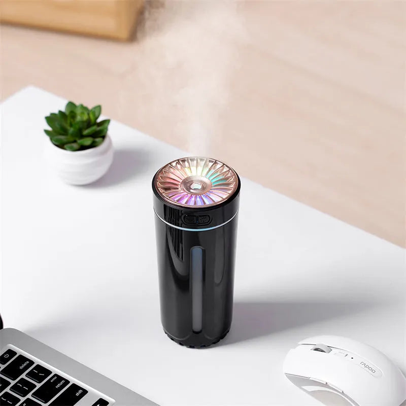 Black portable USB rechargeable humidifier with colourful LED lights on a car cup holder