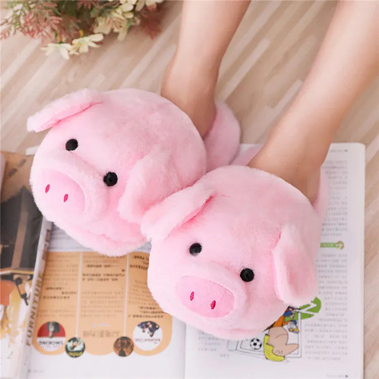 Pink pig-themed plush floor slippers for adults on a white background