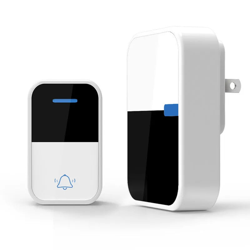 Modern white plastic wireless doorbell receiver and self-generating push-button transmitter on a table.