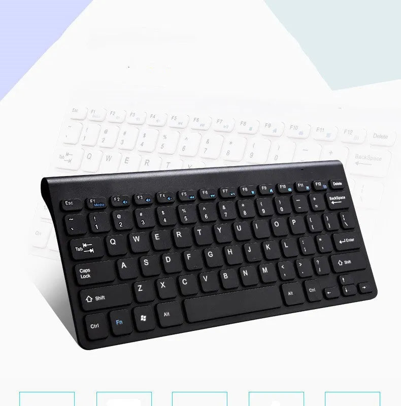 Black and white wireless keyboard and mouse set with USB receiver on a wooden desk.