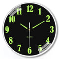 Modern luminous wall clock with plastic shell, 20cm diameter, shown in a room setting.