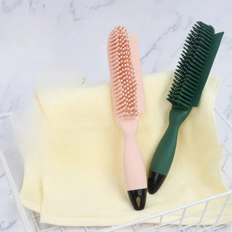 Pink and green handheld pet hair remover brush with grooming comb and integrated clothes hair collector.
