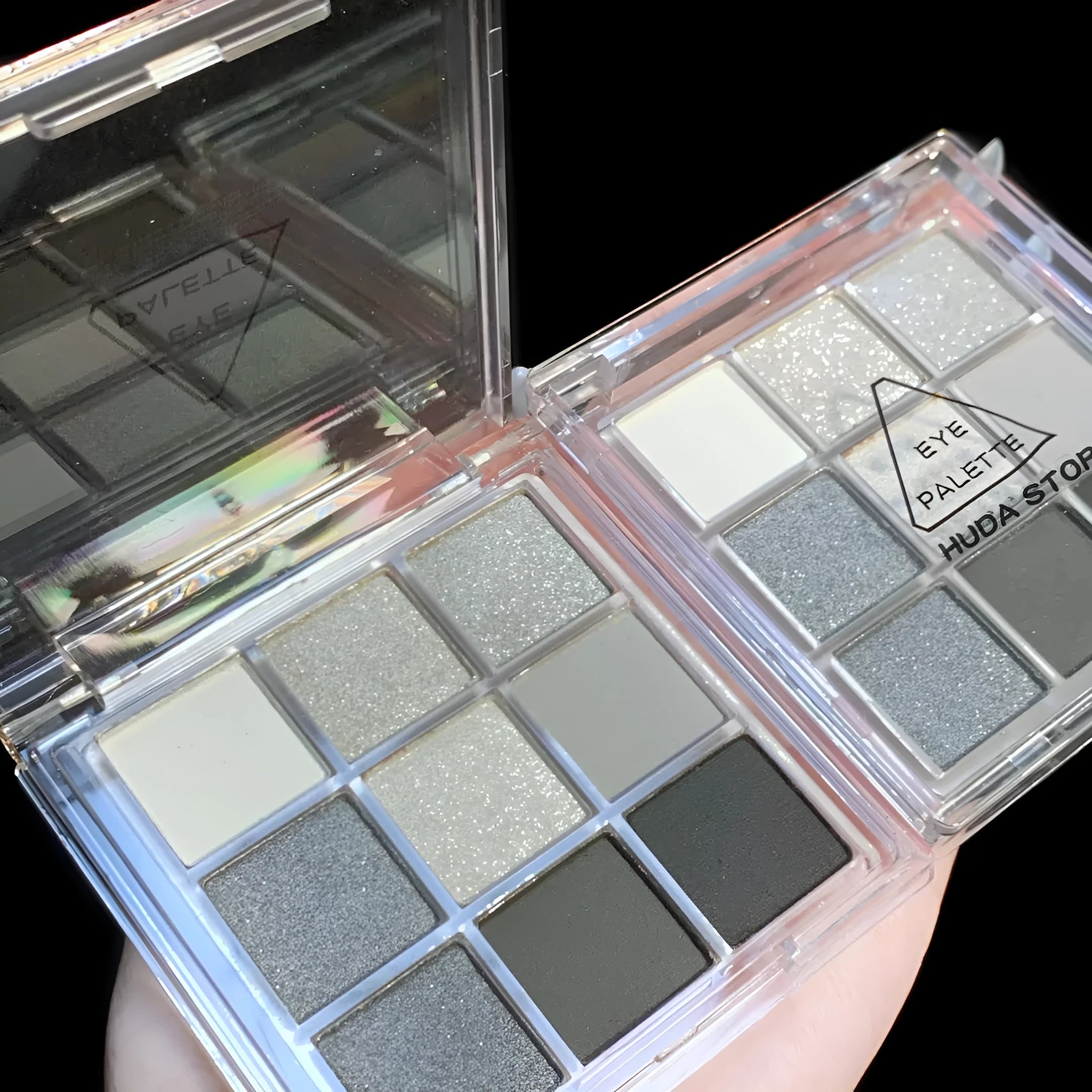 Smoked nine-colour eye shadow palette showing white, silver, black, and iron grey shades.