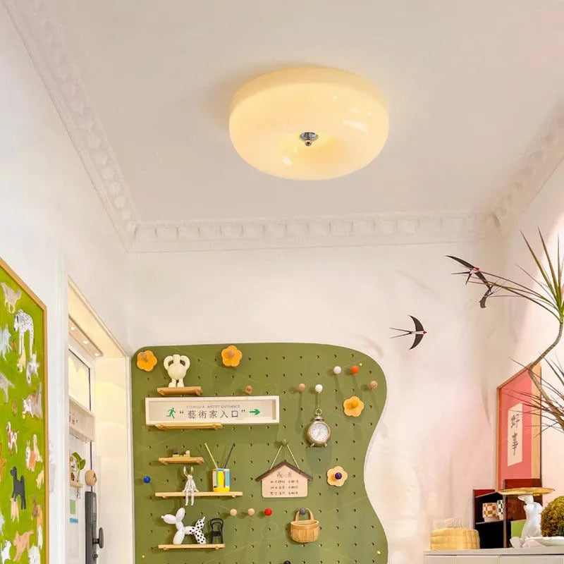 American style cream coloured bedroom ceiling lamp with three-colour light fitting on a white ceiling.