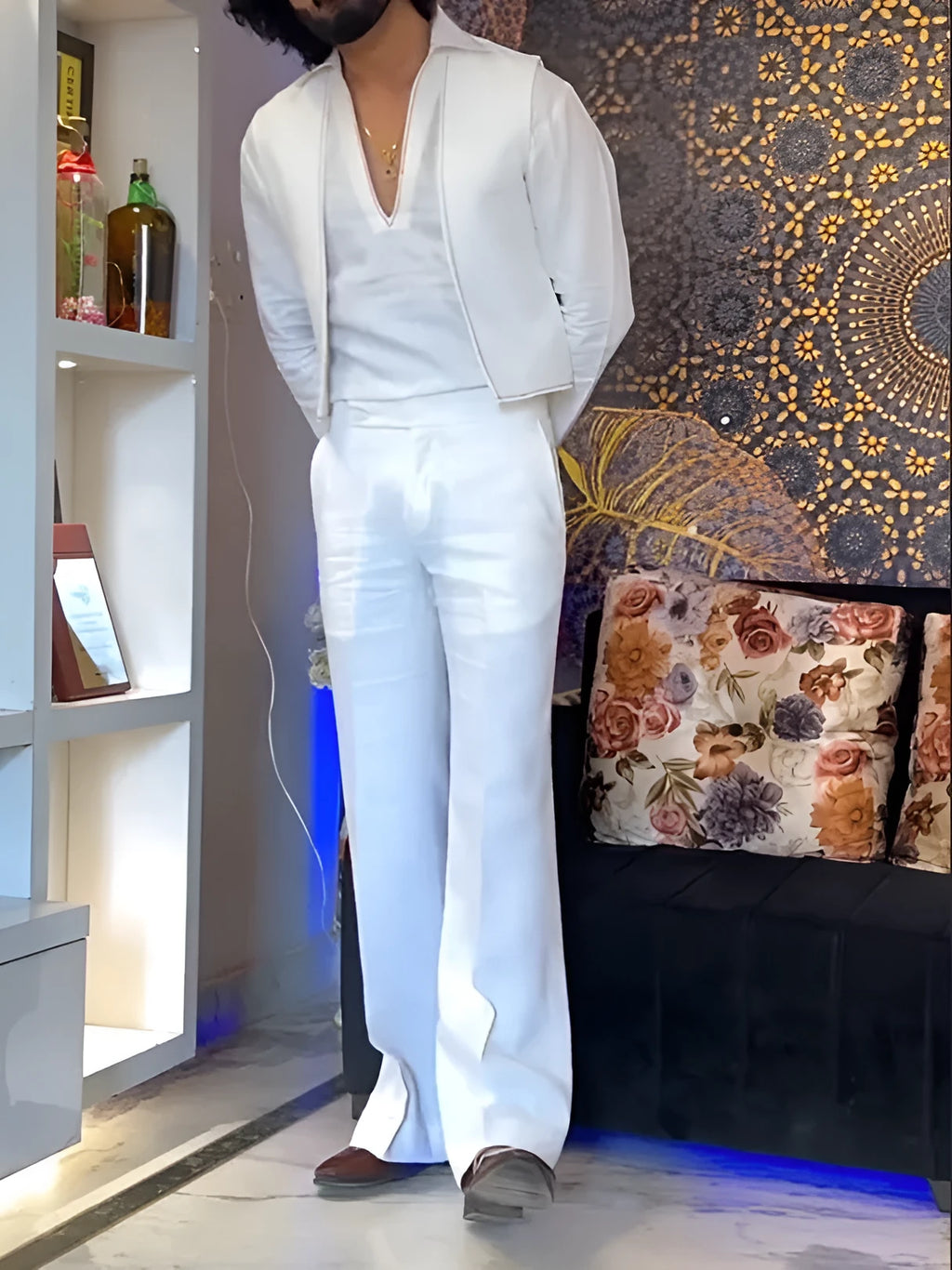 White women's three-piece outfit comprising a V-neck shirt, sleeveless vest, and full-length trousers.