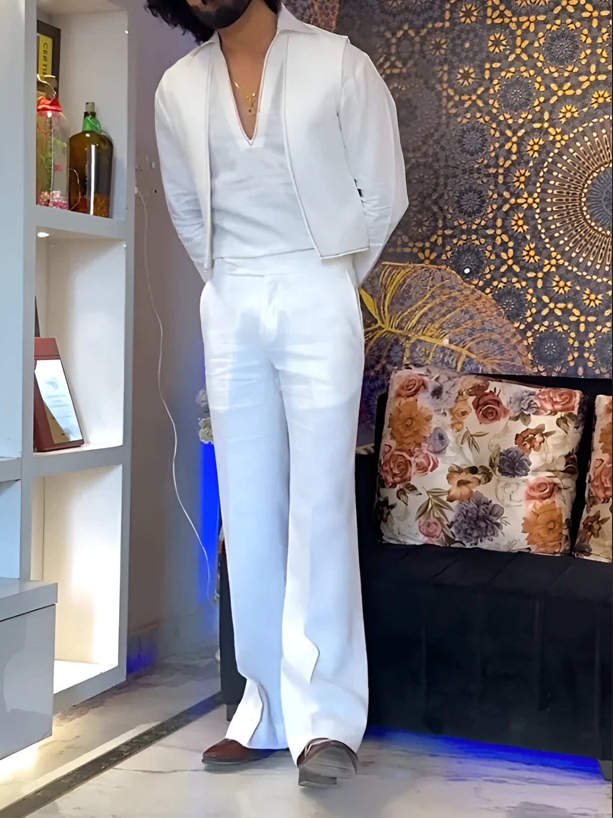 White women's three-piece outfit comprising a V-neck shirt, sleeveless vest, and full-length trousers.