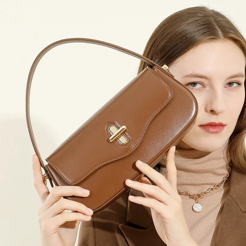 Genuine leather baguette handbag in caramel colour with clamshell design and shoulder straps