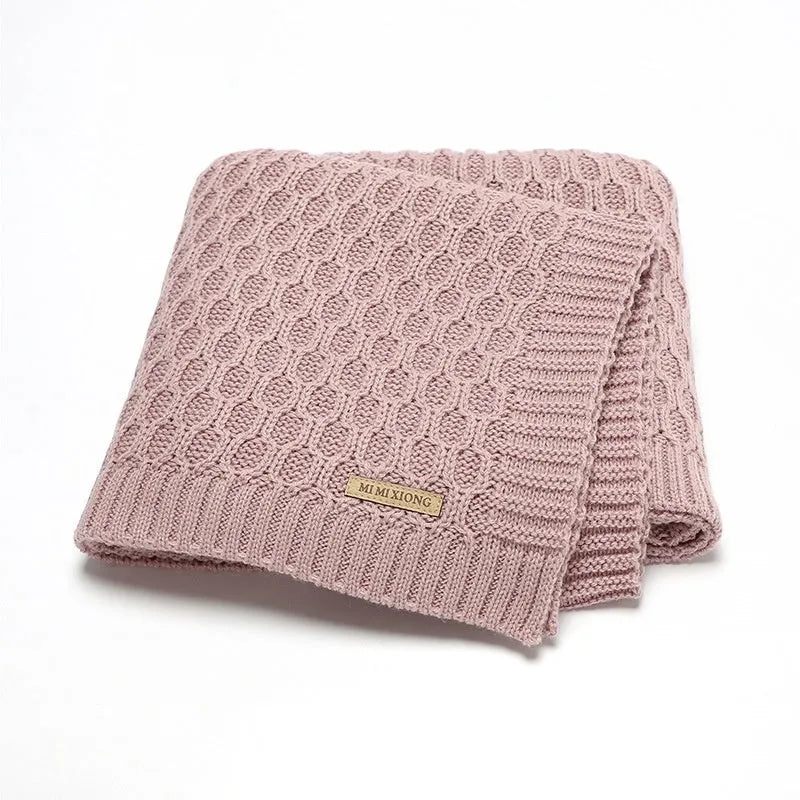 Solid colour acrylic infant blanket with textured lines in beige khaki, laid flat showing 70x90cm size.