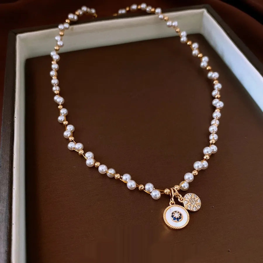 Gold plated clavicle necklace with round imitation pearl and zircon pendant on a 41-50cm chain.