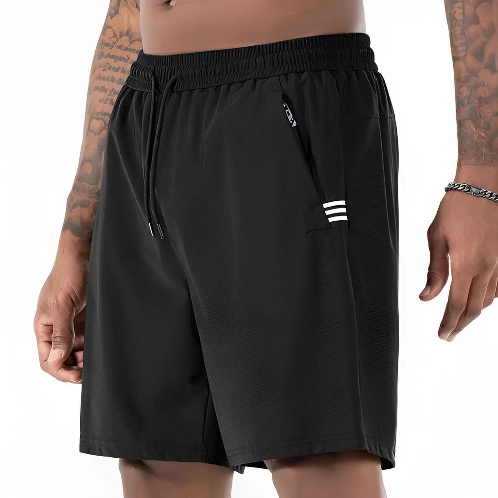 Man wearing black ice silk quick-drying sports shorts with drawstring waist.