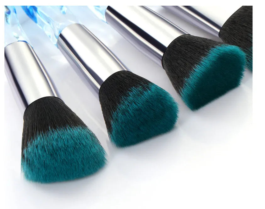 10 clear crystal handle foundation brushes with diamond shanks, showing black, blue, red, and yellow colour options.