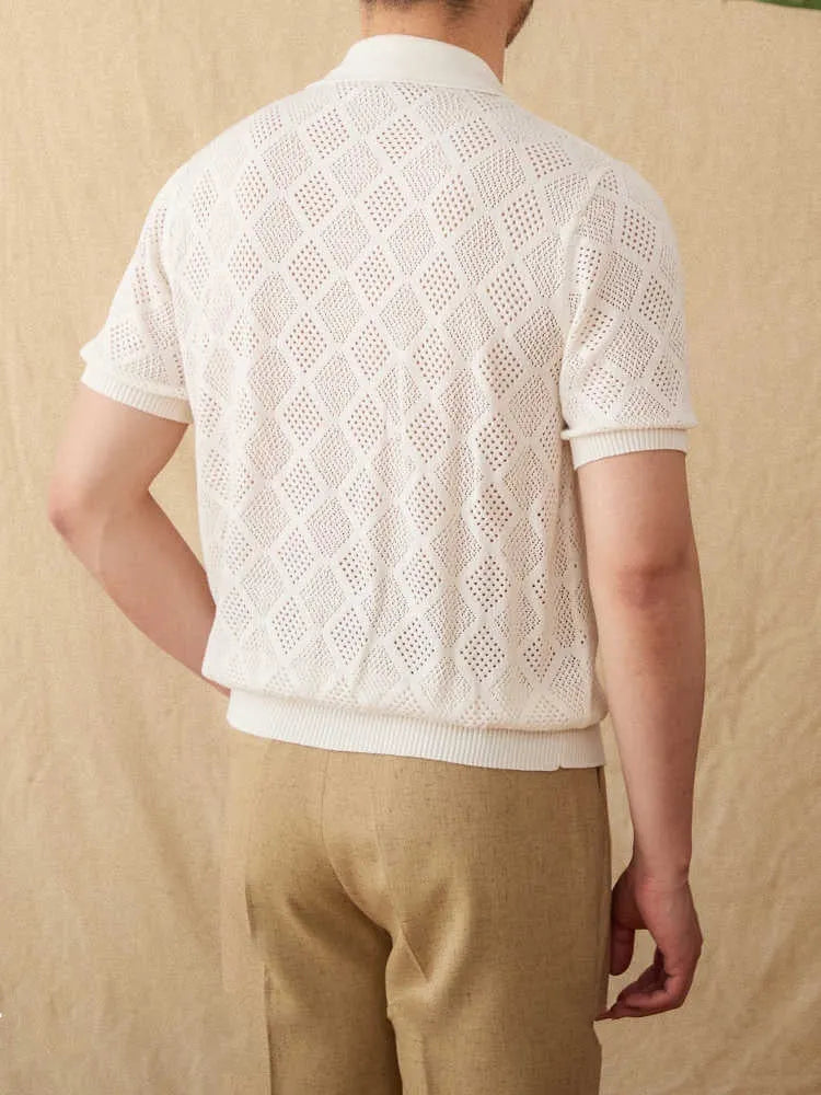 Man wearing a light brown, short sleeve cotton cardigan with a front zipper and lapel collar.