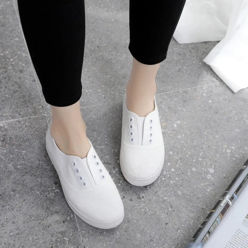A pair of low-top canvas casual shoes in a choice of colours, featuring a flat heel and cloth lining.