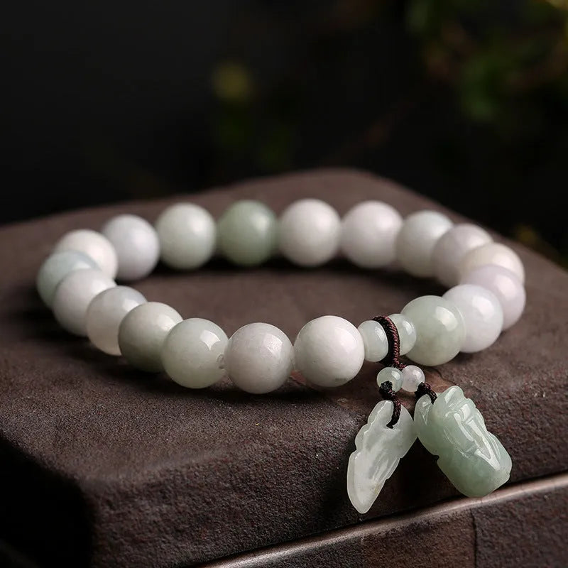 Emerald green jade hanging bracelet with Maitreya Buddha charm and geometric shapes