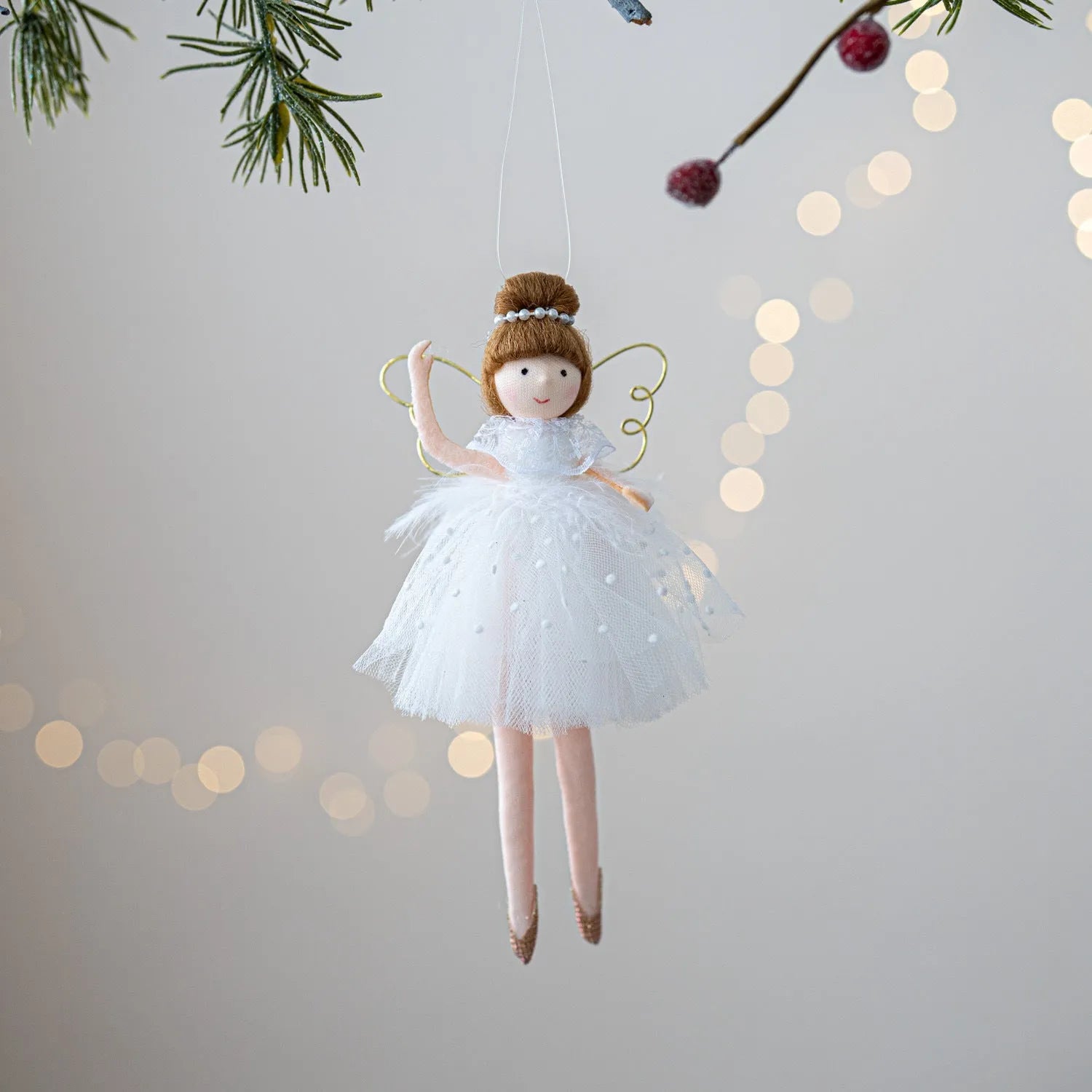 Pink and white cloth ballet girl angel plush doll pendant on a plain background.