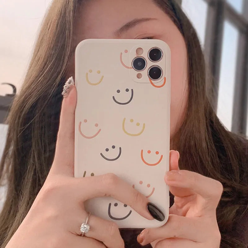 Simple TPU iPhone case with painted smiley face design in three colour options
