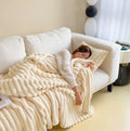 Soft Wind bubble velvet faux rabbit fur blanket in a solid colour, shown folded.