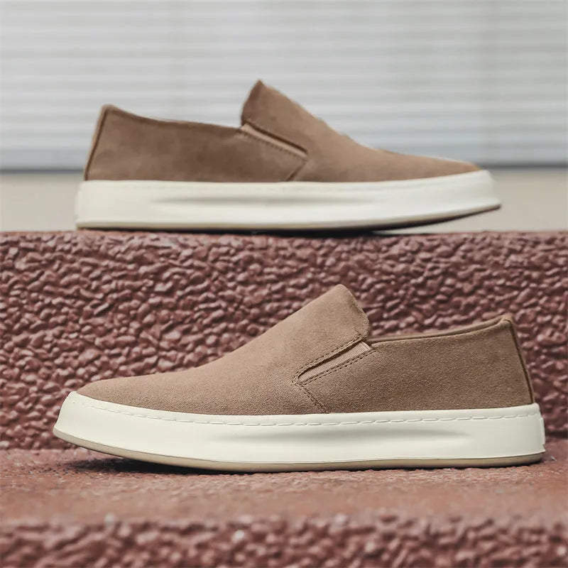 Men's grey casual shoes with round toe design and sewing line detailing showing rubber soles