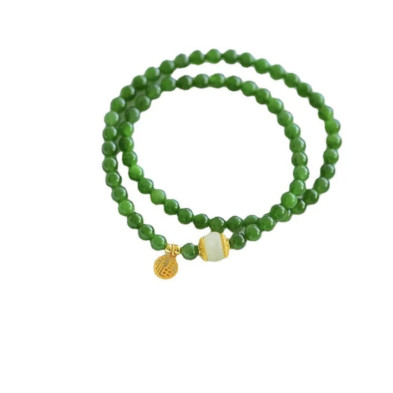 Women's double circle bracelet made from natural Hetian jade with 6mm geometric beads and a fu charm.